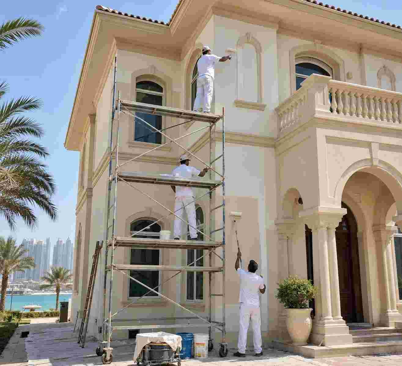Professional painters applying exterior paint to a luxury villa in Palm Jumeirah, Dubai