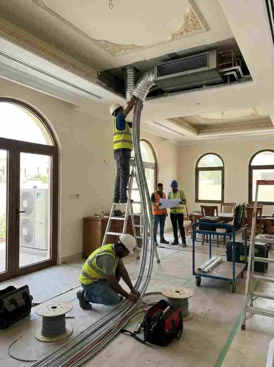 HVAC technician installing a new inverter split AC unit in a Dubai Marina apartment