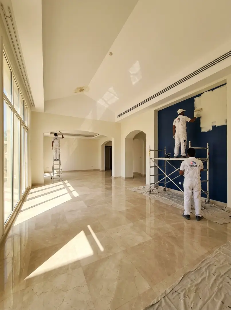 Professional painters repainting the interior walls of a Dubai villa